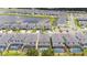 Aerial view of a community with a lake and many houses at 5887 High Seas Dr, Orlando, FL 32821