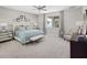 Bright and airy main bedroom with large bed and sitting area at 12934 Promise Pl, Orlando, FL 32832