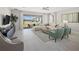 Spacious living room with L-shaped sofa and sliding glass doors leading to patio at 12934 Promise Pl, Orlando, FL 32832
