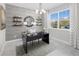 Home office with built-in shelving and large window at 12934 Promise Pl, Orlando, FL 32832