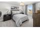 Well-lit bedroom with a full-size bed, nightstands, and window views at 12934 Promise Pl, Orlando, FL 32832