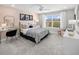 Charming bedroom with a queen bed, desk, and window views at 12934 Promise Pl, Orlando, FL 32832