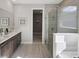 Spa-like bathroom with walk-in shower and double vanity at 12934 Promise Pl, Orlando, FL 32832