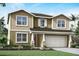 Two-story home with a charming exterior and two-car garage at 12934 Promise Pl, Orlando, FL 32832
