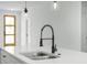 Modern kitchen features a sleek black faucet and white quartz countertops at 602 Marion Oaks Blvd, Ocala, FL 34473