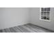 Simple bedroom with gray vinyl flooring and a window at 602 Marion Oaks Blvd, Ocala, FL 34473