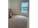 Empty spare bedroom with gray carpeting and large window at 5639 Costa Blanca Way, Davenport, FL 33897