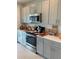 Modern kitchen with gray cabinets and appliances at 5639 Costa Blanca Way, Davenport, FL 33897