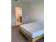 Main bedroom with door to bathroom and light wood bed frame at 5639 Costa Blanca Way, Davenport, FL 33897