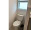Standard toilet and a small, gray wastebasket at 5639 Costa Blanca Way, Davenport, FL 33897