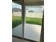 View of backyard through sliding glass doors at 5639 Costa Blanca Way, Davenport, FL 33897