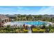 Resort-style pool with lounge chairs, umbrellas, and a shaded seating area at 5639 Costa Blanca Way, Davenport, FL 33897