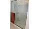 Bathroom shower with sliding glass doors and built-in shelving at 5639 Costa Blanca Way, Davenport, FL 33897