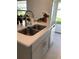 Kitchen island with double sink and white countertop at 5639 Costa Blanca Way, Davenport, FL 33897