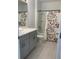 Clean bathroom with gray vanity, bathtub, and shower at 5639 Costa Blanca Way, Davenport, FL 33897