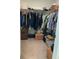 Walk-in closet with hanging clothes and additional shelving at 5639 Costa Blanca Way, Davenport, FL 33897