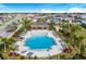 Aerial view of community pool with lounge chairs and cabana at 5639 Costa Blanca Way, Davenport, FL 33897