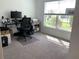 Home office with large window, desk, and comfortable chair at 5639 Costa Blanca Way, Davenport, FL 33897