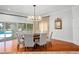 Elegant dining room features a wood table, chandelier, and hardwood floors at 9648 Mccormick Pl, Windermere, FL 34786