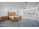 Spacious main bedroom with wood bed frame, plush carpet, and large windows at 9648 Mccormick Pl, Windermere, FL 34786