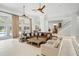 Elegant living room with leather sofas, a large coffee table and access to the pool at 9648 Mccormick Pl, Windermere, FL 34786