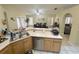 Kitchen with double sink, island, and view into dining area at 11238 Crystal Glen Blvd, Orlando, FL 32837