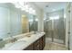 Bathroom with double vanity, shower, and granite countertop at 7432 Marker Ave, Kissimmee, FL 34747