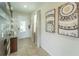 Bright entryway with wood-look wall and glass-top console table at 7432 Marker Ave, Kissimmee, FL 34747