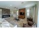 Spacious living room featuring a modern fireplace and large TV at 7432 Marker Ave, Kissimmee, FL 34747