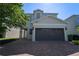 Two-story house with brown garage door and brick paver driveway at 7432 Marker Ave, Kissimmee, FL 34747