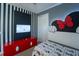 Mickey Mouse themed bedroom with a twin bed and red dresser at 7432 Marker Ave, Kissimmee, FL 34747