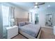 Primary bedroom with king bed, ensuite bathroom access, and decorative wall at 7432 Marker Ave, Kissimmee, FL 34747