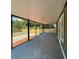 Screened porch with gray decking and views of the backyard at 608 N Summerlin Ave, Orlando, FL 32803