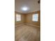 Bright bedroom with light wood flooring and two windows at 608 N Summerlin Ave, Orlando, FL 32803
