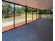 Spacious screened porch with gray decking overlooks fenced backyard at 608 N Summerlin Ave, Orlando, FL 32803