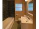 Clean bathroom with dark tile, a bathtub, and a vanity at 608 N Summerlin Ave, Orlando, FL 32803