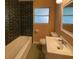 Updated bathroom with dark tile, a bathtub, and a vanity at 608 N Summerlin Ave, Orlando, FL 32803