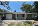 House exterior boasts a green color scheme and a white garage door at 608 N Summerlin Ave, Orlando, FL 32803