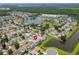 Aerial view showing home's location in a residential neighborhood with lake access at 4704 Cheyenne Point Trl, Kissimmee, FL 34746