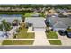 Aerial view of a house with a two-car garage and landscaped front yard at 4704 Cheyenne Point Trl, Kissimmee, FL 34746