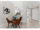Glass-top dining table with four chairs, located near the kitchen at 4704 Cheyenne Point Trl, Kissimmee, FL 34746