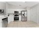 Modern kitchen with stainless steel appliances and white cabinets at 4704 Cheyenne Point Trl, Kissimmee, FL 34746