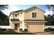 Two-story home with a neutral color scheme and two-car garage at 14649 Erice Ave, Clermont, FL 34714