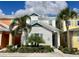 Modern two-story home with light gray exterior and palm trees at 8125 Surf St, Kissimmee, FL 34747