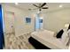 Light and airy bedroom with a queen-size bed and en-suite bathroom at 8125 Surf St, Kissimmee, FL 34747
