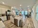 Open concept kitchen with island, stainless steel appliances, and white cabinets at 8125 Surf St, Kissimmee, FL 34747