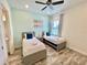 Guest bedroom with two twin beds, ceiling fan, and ensuite bathroom at 8125 Surf St, Kissimmee, FL 34747