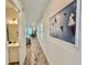 Long hallway with tile floors and artwork at 8125 Surf St, Kissimmee, FL 34747