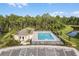 Community pool and clubhouse with surrounding landscape at 273 Reena Dr, Daytona Beach, FL 32117