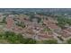 Aerial view of a townhome community, highlighting a specific property with a red roof at 2444 Lobelia Dr, Lake Mary, FL 32746